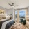 Decorated bedroom with large window and ceiling fan