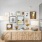 Several paintings hung on wall above dresser